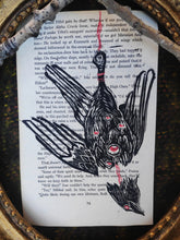 Load image into Gallery viewer, Hanged bird - Linocut printed on book page