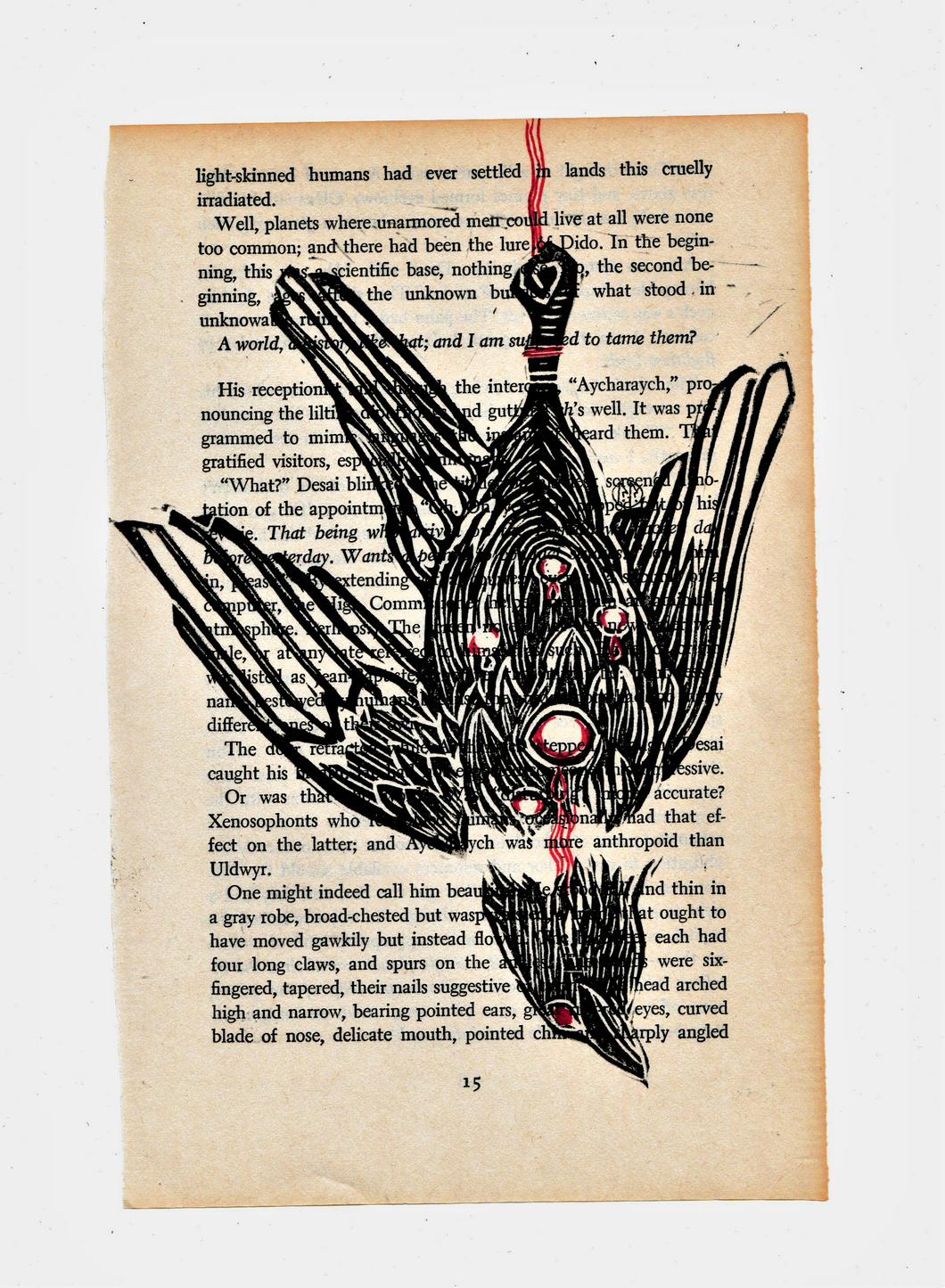 Hanged bird - Linocut printed on book page
